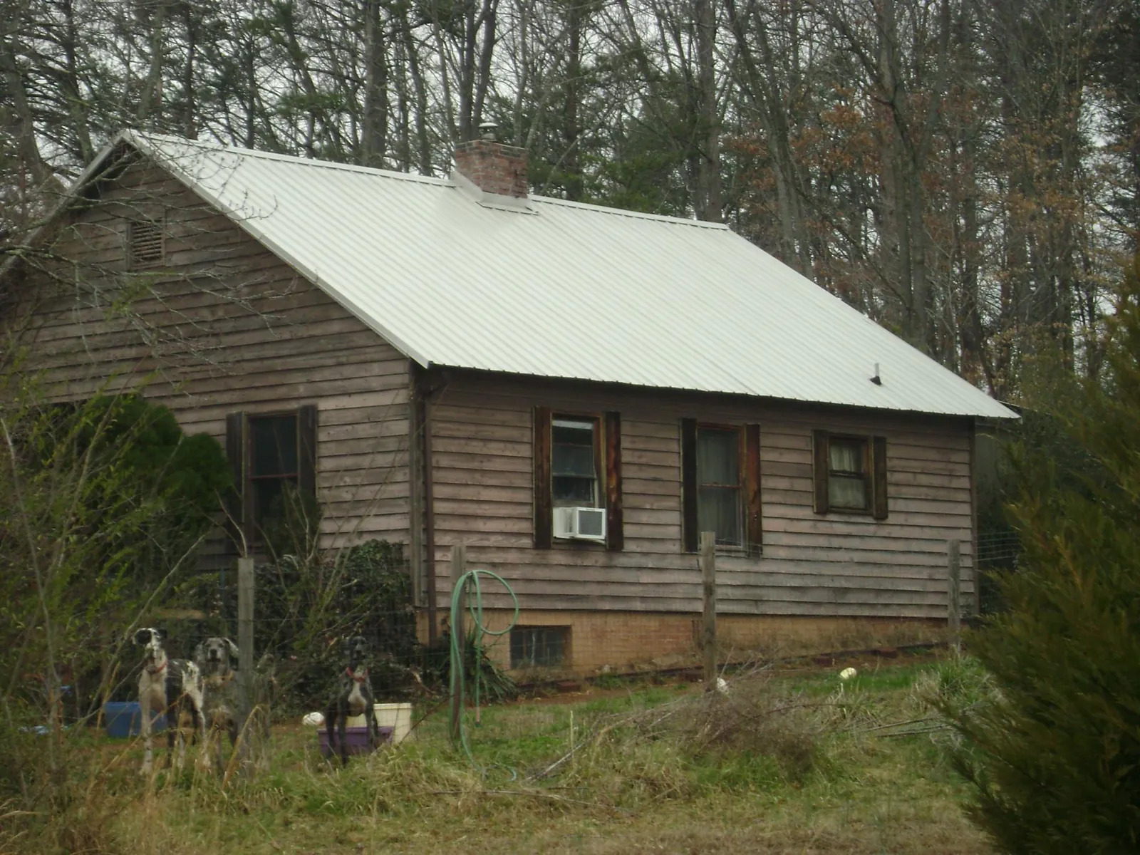 White metal roof on an old wood sided farmhouse, from a Metal Roof Installation job in Kansas City